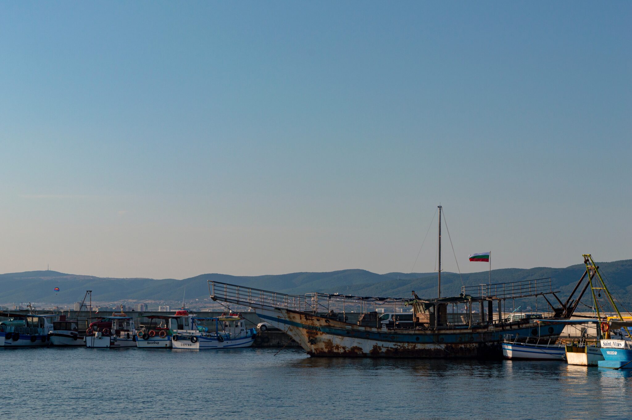 Rusty steel sailboat in a harbor